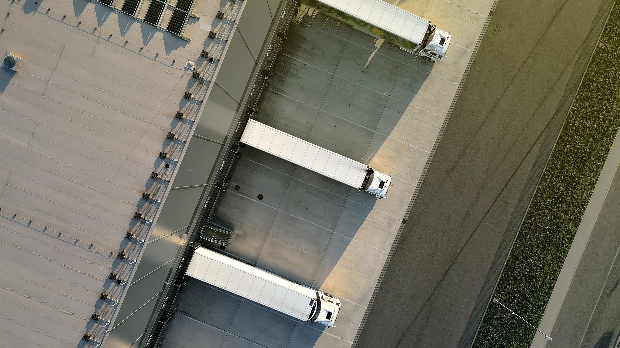 Aerial view of semi trucks parked at distribution center bays