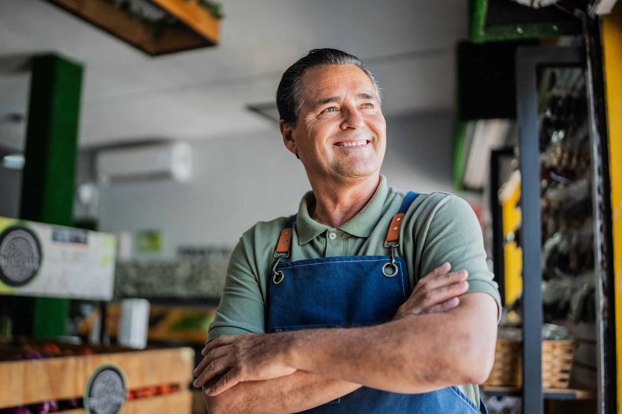 Hardware store employee smiling, arms folded