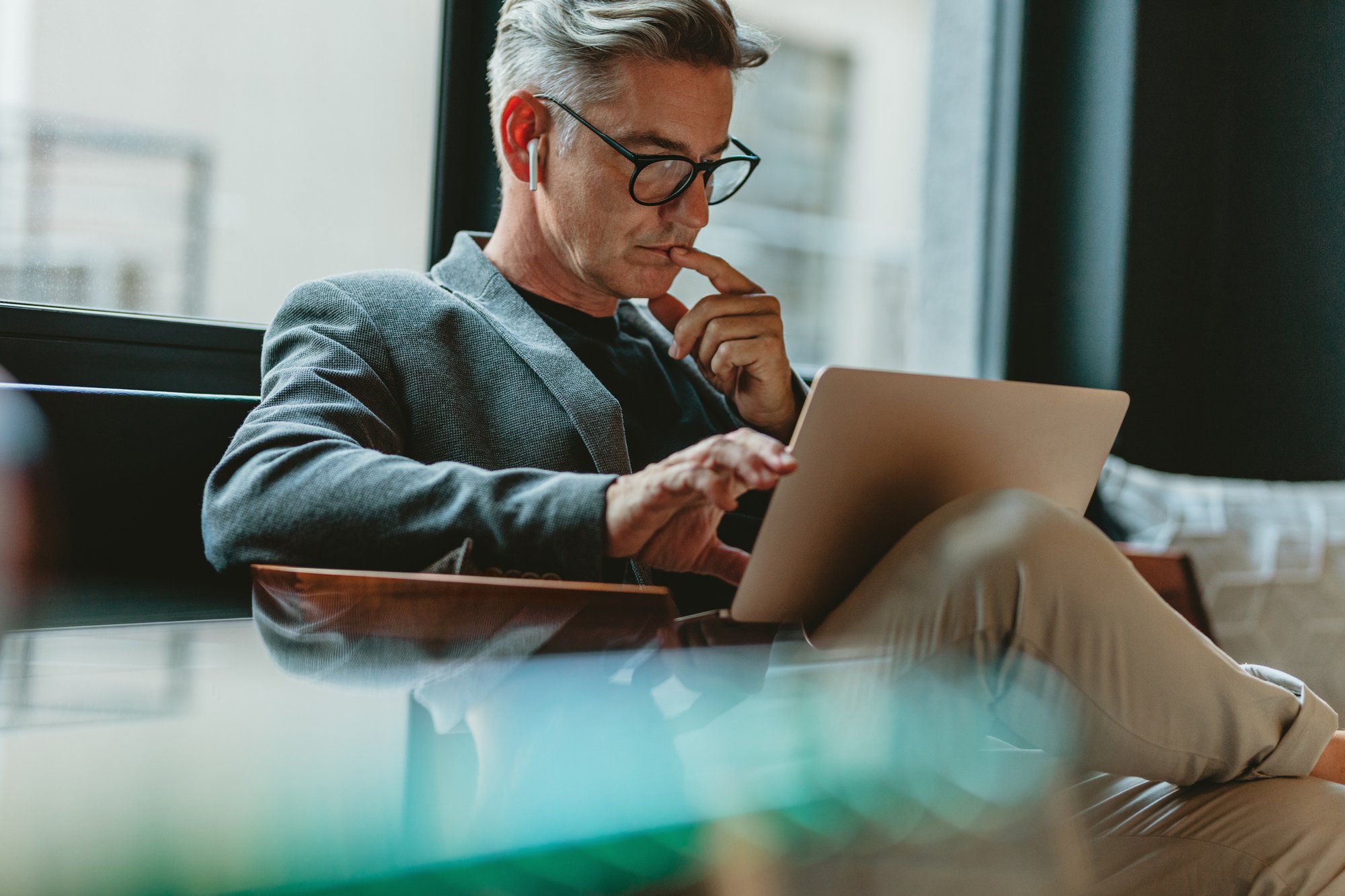 Man using laptop on office couch