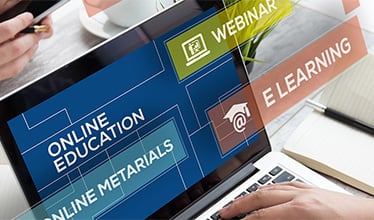 Laptop showing Websource: webinars, e-learning, and online materials