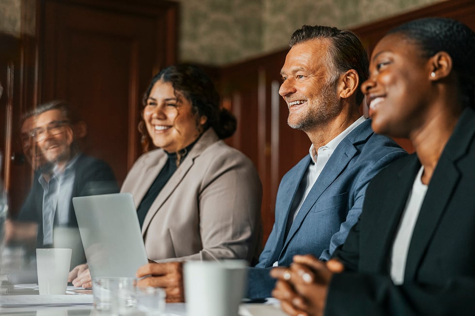 Office workers smiling during meeting